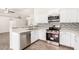 Bright kitchen with white cabinets, stainless steel appliances, and tile flooring at 2047 E Devon Rd, Gilbert, AZ 85296