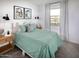 Guest bedroom with a green duvet and wood nightstand at 20775 N Roadrunner Ln, Maricopa, AZ 85138