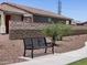 Black metal bench in landscaped park near homes at 20775 N Roadrunner Ln, Maricopa, AZ 85138