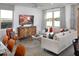 Living room with a sectional sofa and a wooden accent cabinet at 20775 N Roadrunner Ln, Maricopa, AZ 85138