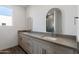 Modern bathroom with double vanity and a large mirror at 2125 E Voltaire Ave, Phoenix, AZ 85022