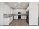 Modern white kitchen with stainless steel appliances at 2125 E Voltaire Ave, Phoenix, AZ 85022