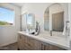 Bathroom with double vanity, quartz countertop, and arched mirrors at 2126 E Voltaire Ave, Phoenix, AZ 85022