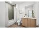 Modern bathroom with gray tile shower and wood vanity at 2126 E Voltaire Ave, Phoenix, AZ 85022