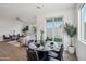 Dining area with a round table and chairs, adjacent to the living room at 2126 E Voltaire Ave, Phoenix, AZ 85022