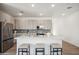 Modern kitchen featuring an island, stainless steel appliances, and white cabinets at 2126 E Voltaire Ave, Phoenix, AZ 85022