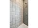 Shower with geometric patterned tile and glass enclosure at 2126 E Voltaire Ave, Phoenix, AZ 85022