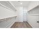 Spacious walk-in closet with ample shelving and hanging rods at 2126 E Voltaire Ave, Phoenix, AZ 85022