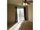 Bedroom with sliding glass door to balcony and ceiling fan at 2208 W Lindner Ave # 17, Mesa, AZ 85202