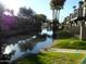 Community canal view with palm trees and buildings at 2208 W Lindner Ave # 17, Mesa, AZ 85202