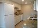 Kitchen with granite countertops and white cabinets at 2208 W Lindner Ave # 17, Mesa, AZ 85202