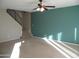 Living room with staircase, teal accent wall, and ceiling fan at 2208 W Lindner Ave # 17, Mesa, AZ 85202