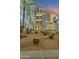 Modern high-rise building with desert landscaping at 2211 E Camelback Rd # 201, Phoenix, AZ 85016