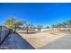 Large backyard with gravel area and mature trees at 232 S San Carlos St, Florence, AZ 85132