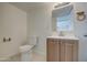 Clean bathroom with wood vanity and tiled floors at 232 S San Carlos St, Florence, AZ 85132