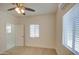 Bedroom with ceiling fan, window coverings, and wood floors at 232 S San Carlos St, Florence, AZ 85132