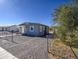 Gray stucco house exterior with chain link fence and gravel yard at 232 S San Carlos St, Florence, AZ 85132