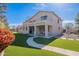 Spacious backyard with lush green grass, a walkway, a patio, and a two story house at 2418 E Glass Ln, Phoenix, AZ 85042