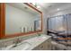 Bright bathroom features double sinks with granite countertops, a large mirror, and a decorative shower curtain at 2418 E Glass Ln, Phoenix, AZ 85042