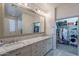 Elegant bathroom features a dual sink vanity with marble countertop and a large framed mirror at 2418 E Glass Ln, Phoenix, AZ 85042