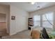 Well-lit bedroom with a ceiling fan and a large window with curtains, along with a bookcase at 2418 E Glass Ln, Phoenix, AZ 85042