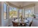 Bright breakfast nook with a round table, large windows, and views of the landscaped outdoors at 2418 E Glass Ln, Phoenix, AZ 85042