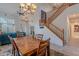 Bright and open dining room with a view of the staircase and living area at 2418 E Glass Ln, Phoenix, AZ 85042