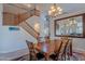 Open dining room with chandelier, staircase, and view of the living area at 2418 E Glass Ln, Phoenix, AZ 85042