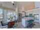 Modern kitchen with stainless steel appliances, granite counters, and a breakfast bar with blue stools at 2418 E Glass Ln, Phoenix, AZ 85042