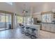 Spacious open-concept kitchen with an island bar, modern appliances, and adjacent sunlit dining area at 2418 E Glass Ln, Phoenix, AZ 85042