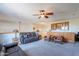 Spacious living room featuring a ceiling fan, wet bar, and comfortable leather seating at 2418 E Glass Ln, Phoenix, AZ 85042