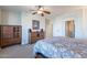 Comfortable main bedroom featuring wood furniture, ceiling fan, and ensuite bathroom at 2418 E Glass Ln, Phoenix, AZ 85042