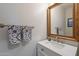 Elegant powder room featuring a marble countertop and decorative mirror and towel rack at 2418 E Glass Ln, Phoenix, AZ 85042