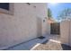 This side yard features a secure gate and low-maintenance gravel landscaping at 2418 E Glass Ln, Phoenix, AZ 85042