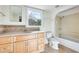 Clean bathroom with light wood cabinets and bathtub at 26207 S Lime Dr, Queen Creek, AZ 85142