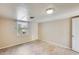 Simple bedroom with tile floors and a window at 26207 S Lime Dr, Queen Creek, AZ 85142