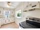 Kitchen with white cabinets, floral details, and stainless steel appliances at 26207 S Lime Dr, Queen Creek, AZ 85142