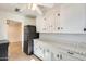 White cabinets and sunflower-patterned countertops in kitchen at 26207 S Lime Dr, Queen Creek, AZ 85142