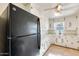 Kitchen features black refrigerator and white cabinets at 26207 S Lime Dr, Queen Creek, AZ 85142