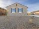 Gray house exterior with blue shutters and a neatly landscaped front yard at 2669 E Santa Ynez Dr, Casa Grande, AZ 85194