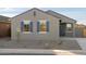 Two-toned home exterior with gray siding, blue shutters, and a dark blue front door at 2669 E Santa Ynez Dr, Casa Grande, AZ 85194