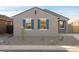 Modern curb appeal with gray exterior, blue shutters, and rock landscaping at 2669 E Santa Ynez Dr, Casa Grande, AZ 85194