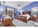 Main bedroom with wood bed frame and blue walls at 2673 W Ivanhoe St, Chandler, AZ 85224