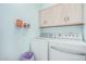 Laundry room with washer, dryer, and upper cabinets at 2673 W Ivanhoe St, Chandler, AZ 85224