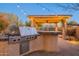 Built-in outdoor grill with a side burner and prep area at 32029 N 19Th Ln, Phoenix, AZ 85085