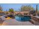 Inviting backyard oasis featuring a sparkling pool, waterfall, and relaxing patio at 32029 N 19Th Ln, Phoenix, AZ 85085