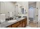 Double sink bathroom with wood cabinets and a shower/tub combo at 32029 N 19Th Ln, Phoenix, AZ 85085