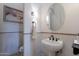 Elegant powder room with pedestal sink and oval mirror at 32029 N 19Th Ln, Phoenix, AZ 85085