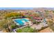 Aerial view of community pool with surrounding lounge chairs and playground at 32029 N 19Th Ln, Phoenix, AZ 85085