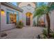 Inviting front courtyard with brick pavers and lush landscaping at 32029 N 19Th Ln, Phoenix, AZ 85085